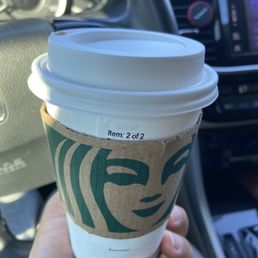 a hand holding a cup of coffee