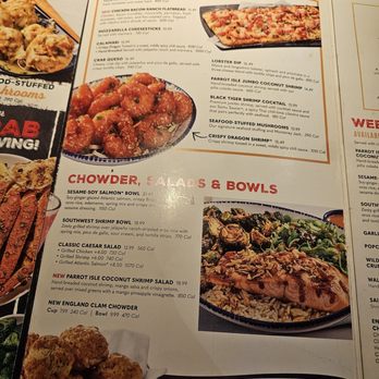 Red Lobster - The menu features starters like calamari and crab queso, with a photo of a flatbread. It also lists salads and bowls, including shrimp and salmon options. - Seafood Near Me - Gresham, Oregon