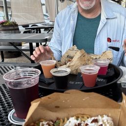 front is loaded waffle fries & the Strawberry-Rhubarb Seltzer; Back is a flight of sours.