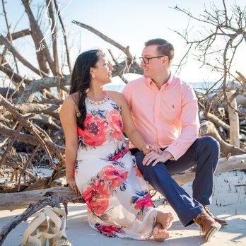 Sandhill Photography - Beer Can Island Photography, and Engaged couple sit on a drift wood log on a beach on Longboat Key. - Event Photography Near Me - Bradenton, Florida Sandhill Photography - Beer Can Island Photography, and Engaged couple sit on a drift wood log on a beach on Longboat Key. - Event Photography Near Me - Bradenton, Florida