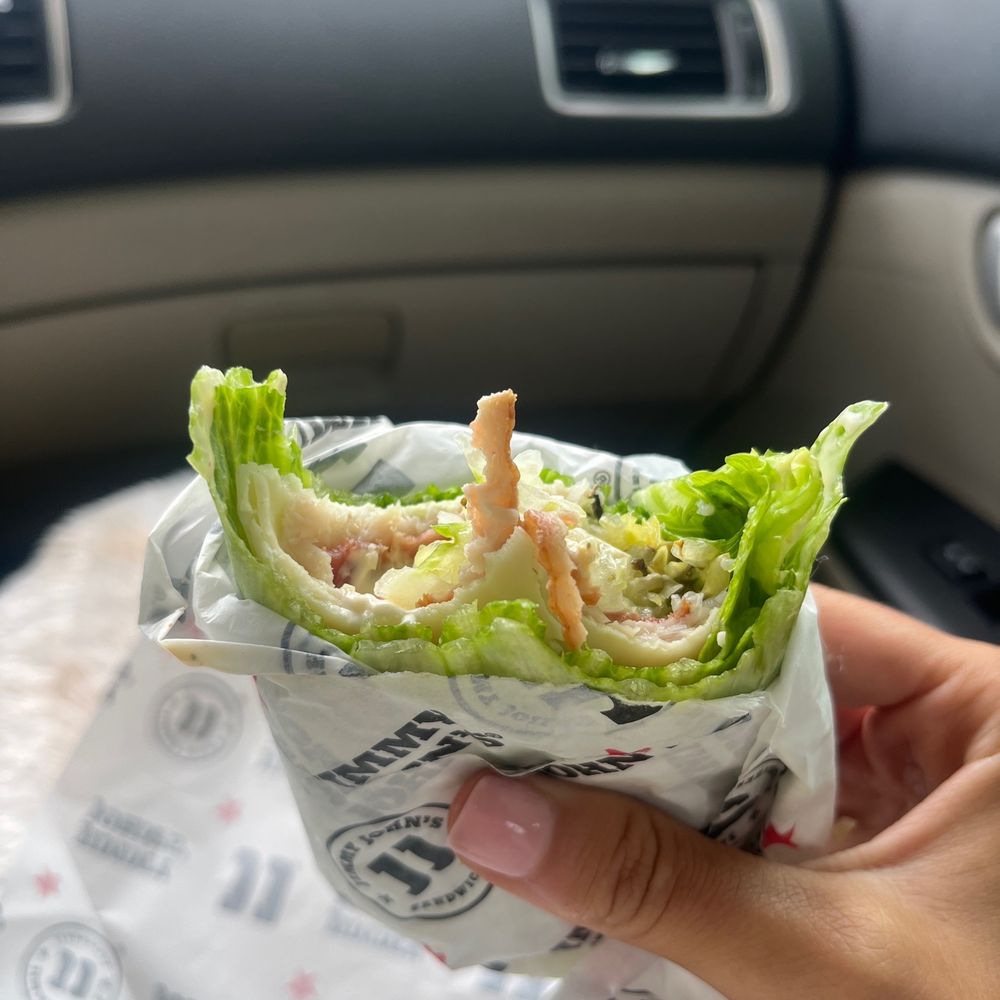 a hand holding a wrap of food
