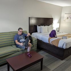 Quality Inn & Suites By The Parks - Room with king bed and couch