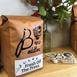 Brew Peddler Coffee - House-roasted beans and stickers.