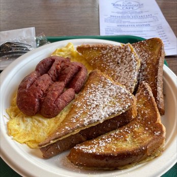 Breakhouse Cafe - Old Fashioned French Toast, Side of Beef Sausage, scrambled eggs - A plate of French toast topped with powdered sugar, served with scrambled eggs and sausage links, at a breakfast restaurant. - Breakfast & Brunch Near Me - Brooklyn, New York