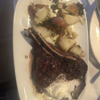 Cork & Cow - Bone in ribeye paired with 2 red potatoes - Steakhouses Near Me - Franklin, Tennessee