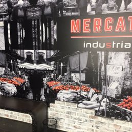 a man standing in front of a display of tomatoes