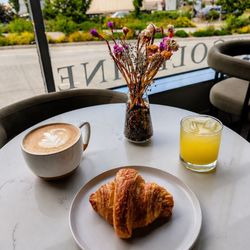 Vitamin C Mocktail along with a mocha and a butter croissant with a view of the harbor