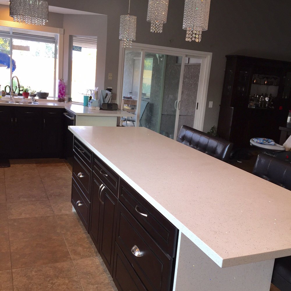 AAA Remodeling & Restoration - large island white quartz with waterfall overhang. Lots of drawers in the island with large cabinet in the middle. Seats 7 - General Contractors Near Me - lake balboa, California