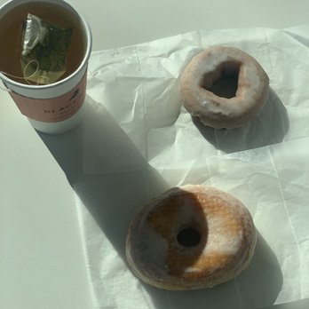 Blackbird Doughnuts - Harvard Square - Top view of blackbird donut, vanilla glazed donut and hot green tea - Donuts Near Me - Cambridge, Massachusetts