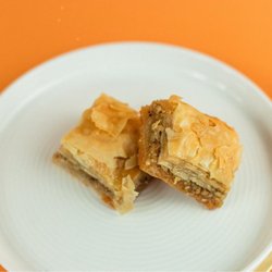 Santorini's - Baklava at Santorini's West Bountiful: Flaky phyllo pastry layers filled with chopped nuts and honey. A classic sweet Greek treat!
