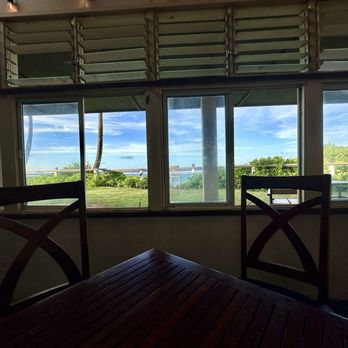 Opakapaka Grill and Bar - Indoor seating area looking out towards ocean and patio. - American Near Me - Hanalei, Hawaii