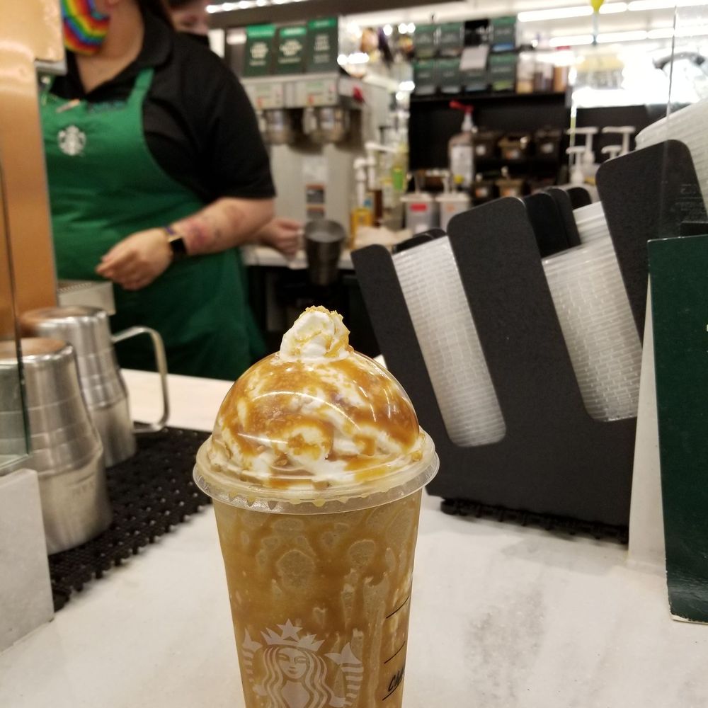 a cup of iced coffee on a counter a cup of iced coffee on a counter