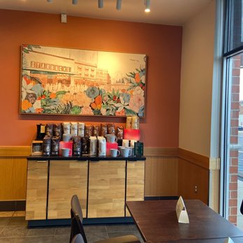 Starbucks - a view of a coffee shop with a painting on the wall - Coffee & Tea Near Me - Chattanooga, Tennessee