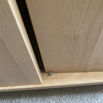 First Class Movers - Closeup of cabinet door, somehow shoved to the inside. - Movers Near Me