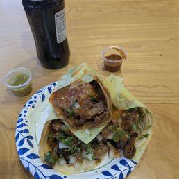 Tres pastor tacos and a coke