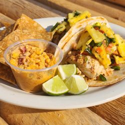 Rivals Taphouse - Mahi Tacos; Marinated and grilled Mahi on a flour tortilla topped with pineapple pico de gallo and ancho chili slaw served with loaded corn