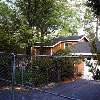 Griner Construction - a house behind a chain link fence - General Contractors Near Me Griner Construction - a house behind a chain link fence - General Contractors Near Me