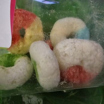SubZero Goodies - The mixed gummy rings included some of each of the 4 flavors of gummy rings. - The image shows a clear plastic bag filled with frozen gummy rings of various colors, including red, white, green, and blue. The gummy rings are coated with a layer of powdered sugar or similar dusting. The bag appears to be sealed or closed, and the gummies are stacked inside, with some overlapping each other. The background is not clearly visible, but the focus is on the colorful, frozen gummy candies. - Specialty Food Near Me
