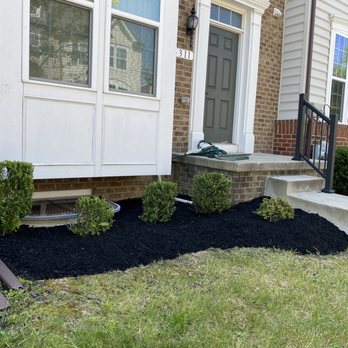 J Lawn Care - black mulch in front of a house - Lawn Services Near Me