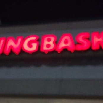 Wingbasket - a neon sign on the side of a building - Chicken Wings Near Me - Madison, Tennessee