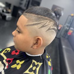 Barber’s Empire - Mid Fade with a design