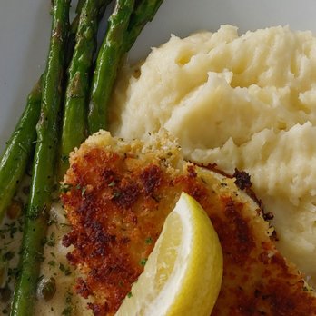 Caps On The Water - Panko crusted Chilean sea bass with grilled asparagus and mashed potatoes. Aaaaaamazing! - Seafood Near Me - St Augustine, Florida