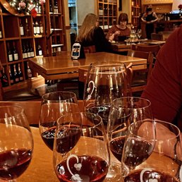 a man sitting at a table with wine glasses a man sitting at a table with wine glasses