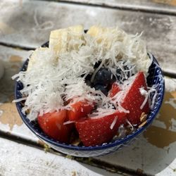 Lots of fruit and yogurt in a small bowl.