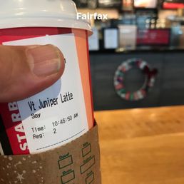 a hand holding a cup of coffee a hand holding a cup of coffee