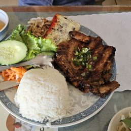 Com Tam. Includes pork chop, egg cake, and shredded pork skin. Com Tam. Includes pork chop, egg cake, and shredded pork skin.