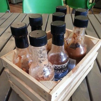 Sauce And Bread Kitchen - Homemade hot sauce in cute crates at each table - Breakfast & Brunch Near Me - Chicago, Illinois