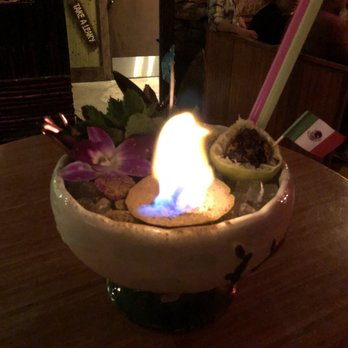 Lei Low - The tiki party bowl my friend and I got, completed with flaming rum-soaked lime (?)... might be some other fruit, AND fried crickets! - Cocktail Bars Near Me - Houston, Texas