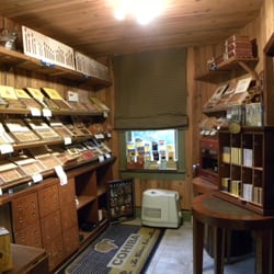 Cigar Bodega - Large selection of product displayed in the walk-in humidor with the entire back section dedicated to Cuban product.
