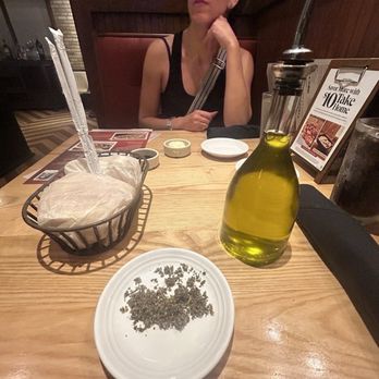 Carrabba's Italian Grill - Warm bead, herbs and olive oil for starters. - Italian Near Me - Jacksonville Beach, Florida Carrabba's Italian Grill - Warm bead, herbs and olive oil for starters. - Italian Near Me - Jacksonville Beach, Florida