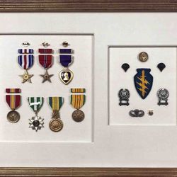 Mangoe Arts & Framing - military medals , framed in custom gilt gold picture frame with hand wrapped fabric matting.