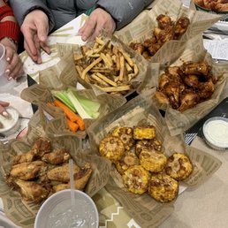 Spread of wings, fries, fried corn, and veggies. Spread of wings, fries, fried corn, and veggies.