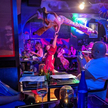 Superfrico - Two acrobatic performers doing a balancing act in the main dining room. - Italian Near Me - Las Vegas, Nevada