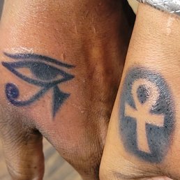 Couple tat of Eye of Horus and Ank.