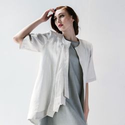 Laura Tanzer - Asymmetry rules this pleat front jacket with a jewel neckline, 3/4 sleeve, pleats at right front and an asymmetric hemline.
