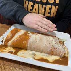 Montezuma Mexican Restaurant - Hand to show how massive the California burrito is.