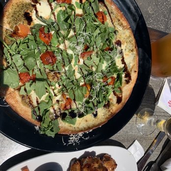 Boston Pizza - a plate of chicken wings and a pizza - Pizza Near Me - Orangeville, Ontario