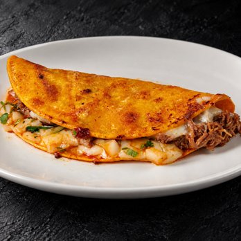 Fuego Cravings - 6" corn tortilla taco, filled with melted cheese, tender birria, fresh onion, and cilantro. - Mexican Near Me - Upland, California Fuego Cravings - 6" corn tortilla taco, filled with melted cheese, tender birria, fresh onion, and cilantro. - Mexican Near Me - Upland, California