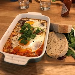 Mahlo Brunch Bar - Spicy bean and tomato baked eggs with sour dough toast, lemon and guacamole