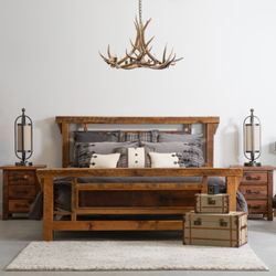 Wild West Designs - An elk antler chandelier hangs over a bedroom set crafted from reclaimed barn wood.