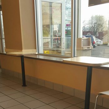Dunkin' - a table and a chair in front of a window - Donuts Near Me - Port Chester, New York Dunkin' - a table and a chair in front of a window - Donuts Near Me - Port Chester, New York