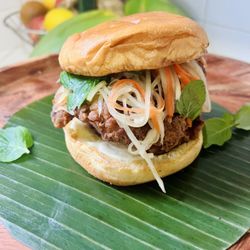 Kreung Kitchen - Cambodian Chicken Sandwich. Marinated in Kreung (lemongrass paste) deep fried with rice flour (gluten free), topped with pickled papaya