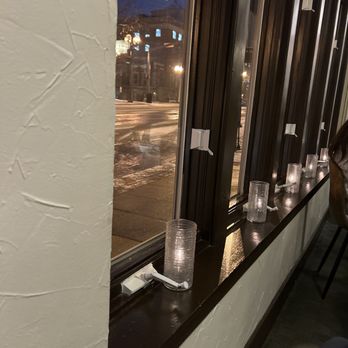 The Crossing - a row of candles on a window sill - New American Near Me - Clayton, Missouri