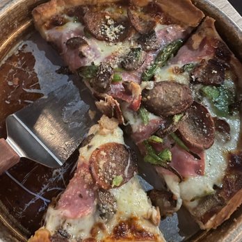Two Cities Pizza - Chicago deep dish with sausage, mushrooms, green peppers, and signature white sauce. - Pizza Near Me - Suwanee, Georgia Two Cities Pizza - Chicago deep dish with sausage, mushrooms, green peppers, and signature white sauce. - Pizza Near Me - Suwanee, Georgia