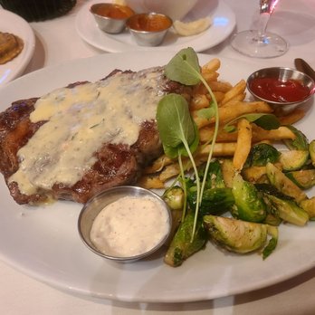 The Vineyard Rose Restaurant - 16 OZ BONE-IN RIBEYE & FRITES Garlic Parmesan Pommes Frites | Roasted Brussel Sprouts | Béarnaise Sauce | Pink Peppercorn Aioli - New American Near Me - Temecula, California The Vineyard Rose Restaurant - 16 OZ BONE-IN RIBEYE & FRITES Garlic Parmesan Pommes Frites | Roasted Brussel Sprouts | Béarnaise Sauce | Pink Peppercorn Aioli - New American Near Me - Temecula, California