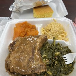 Dorothy's Soul Food Kitchen - Smothered pork chop, greens, Mac n cheese, yams, and cornbread.